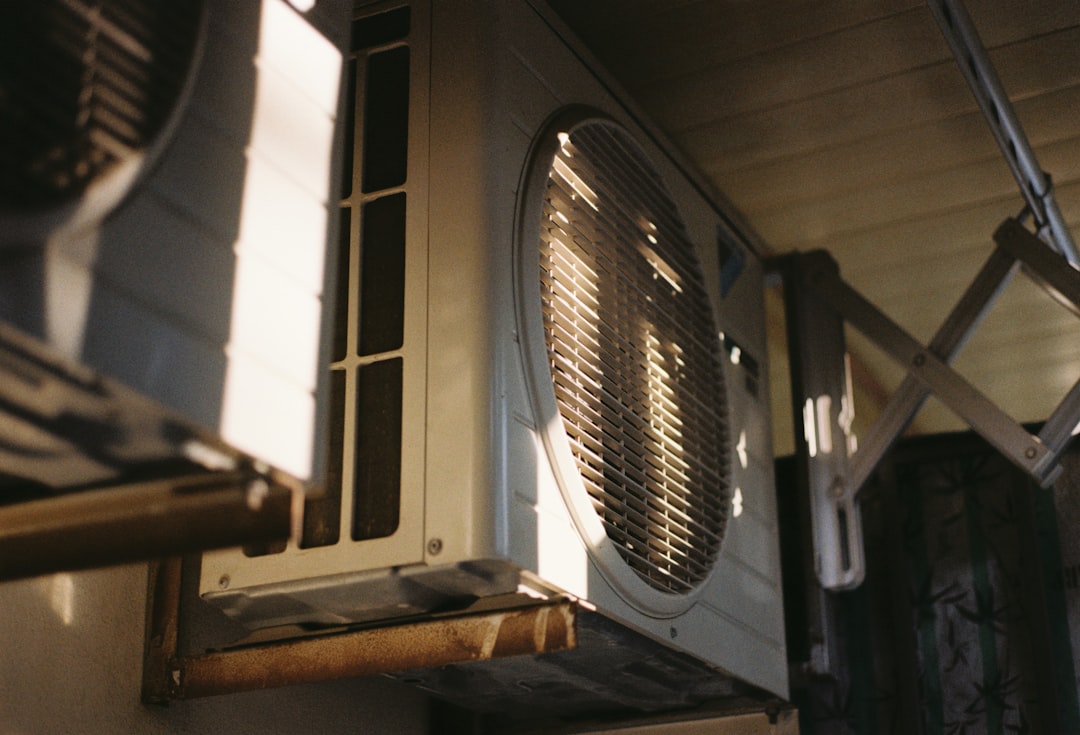 Close-up of a residential air conditioning unit mounted outdoors on a sunny day