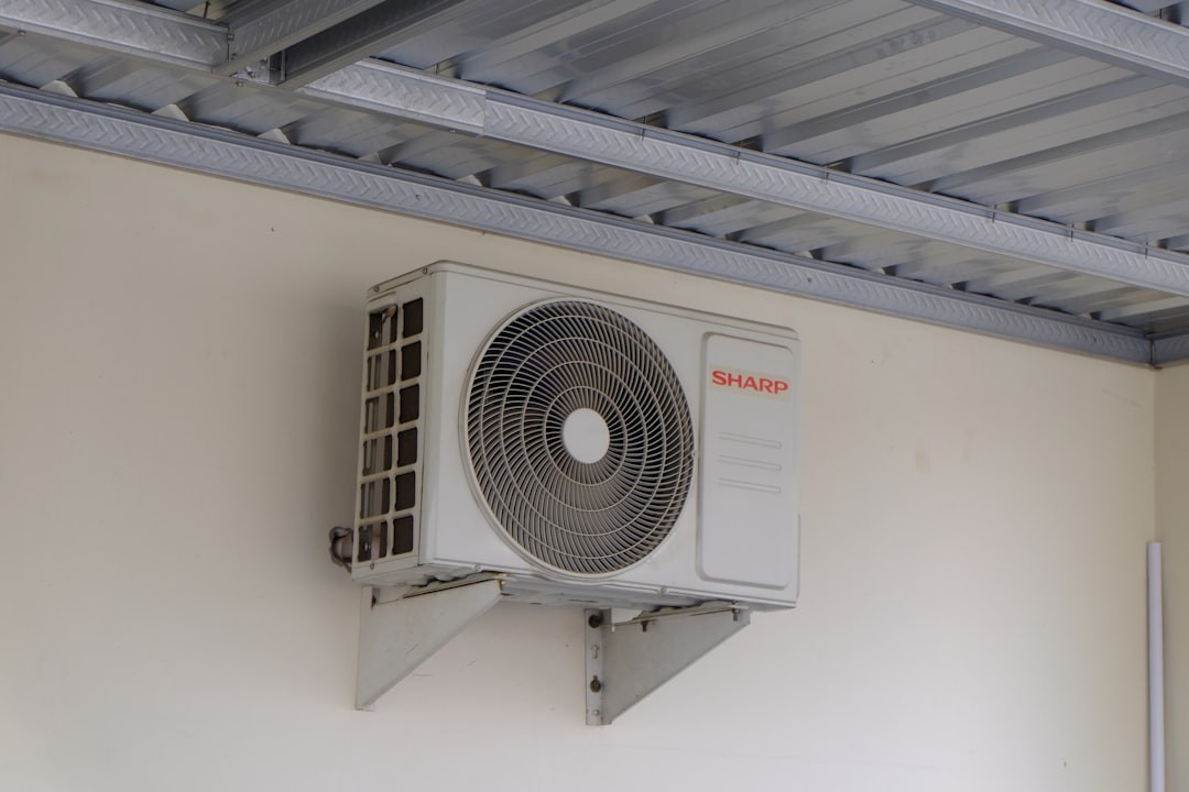 Outdoor air conditioning unit mounted on a wall of a residential building