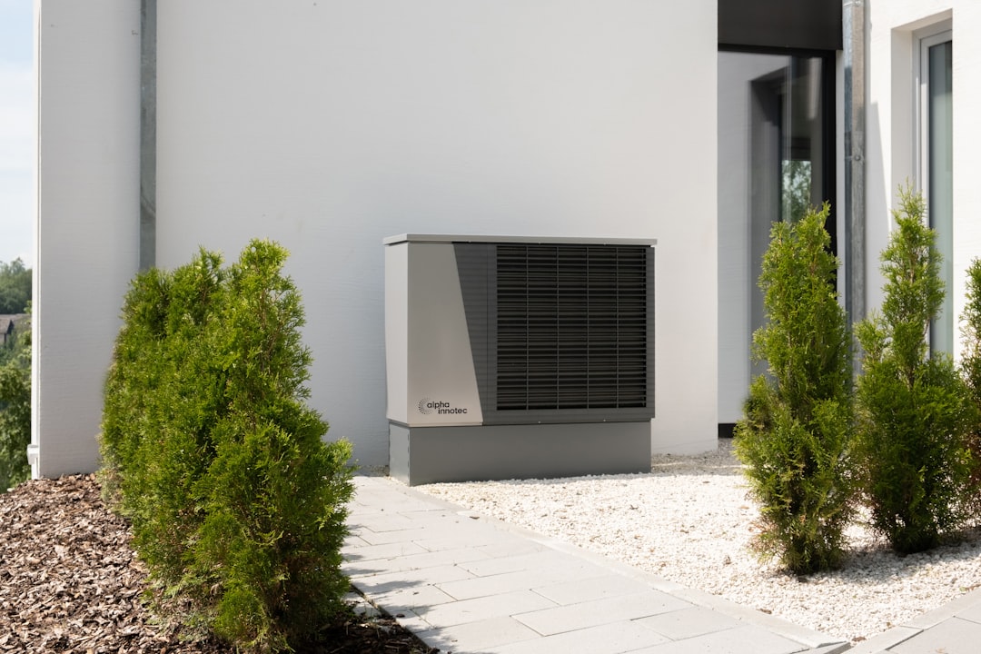 Outdoor central air-conditioning condenser beside a home